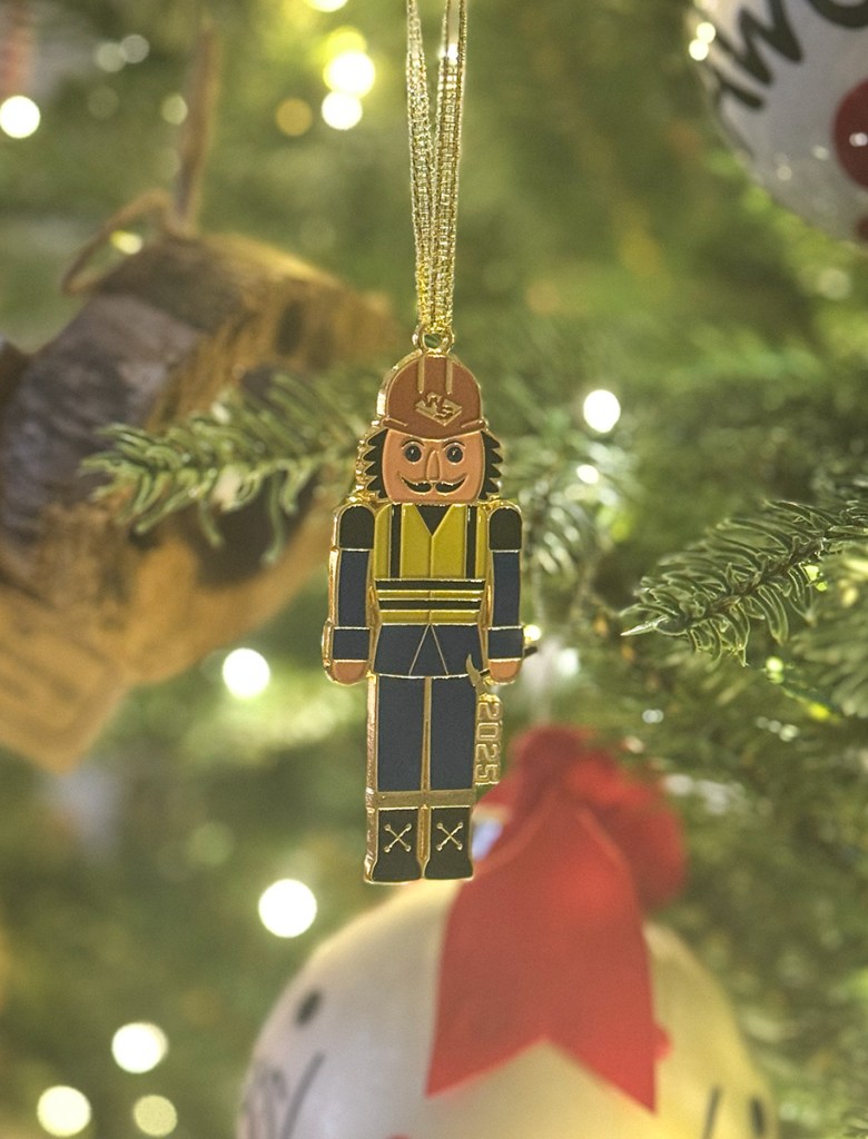 The actual nutcracker ornament hanging on a Christmas tree
